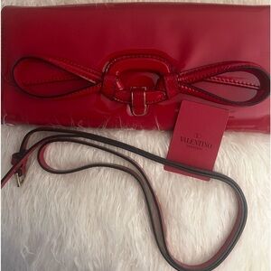 Valentino patent leather clutch bag. Comes with a removable strap.